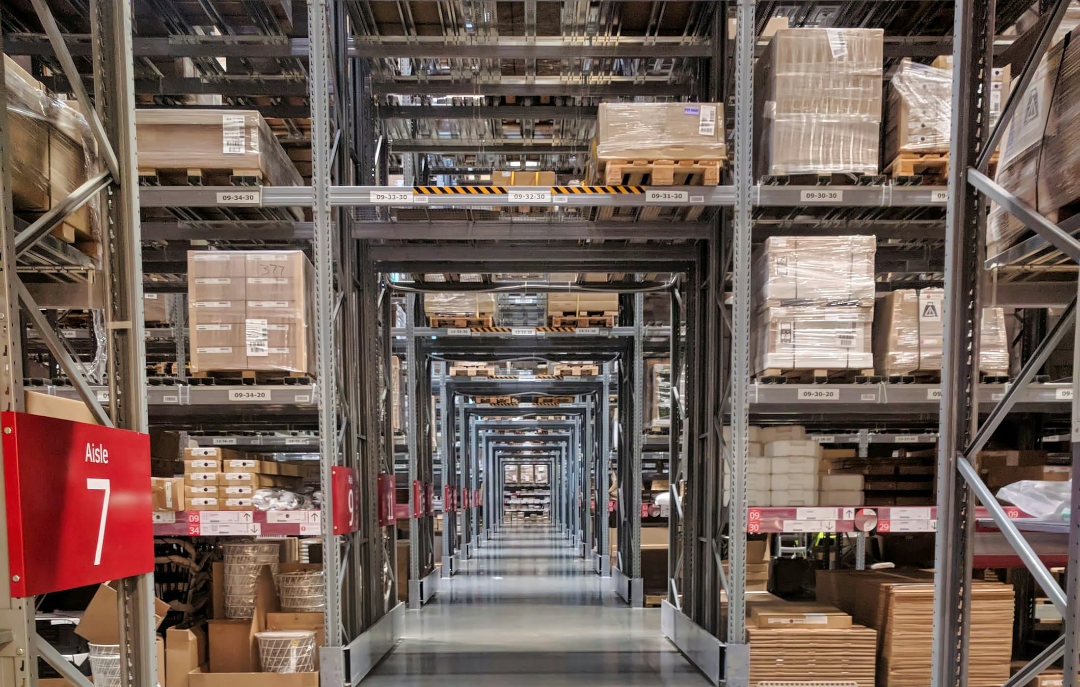 Wide aisle in a distribution warehouse stocked with packaged goods