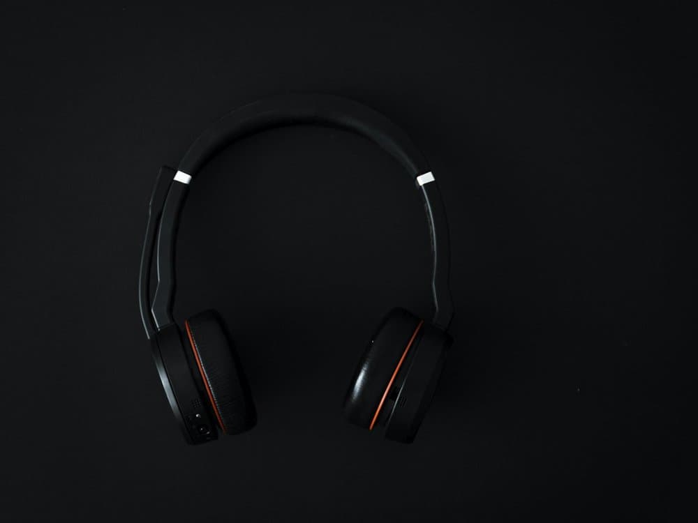 Wireless headphones on a plain dark background, product shot